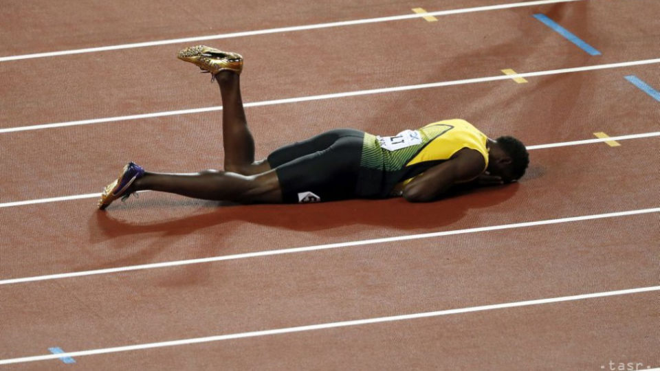 Zranený Usain Bolt leží na dráhe štadióna.