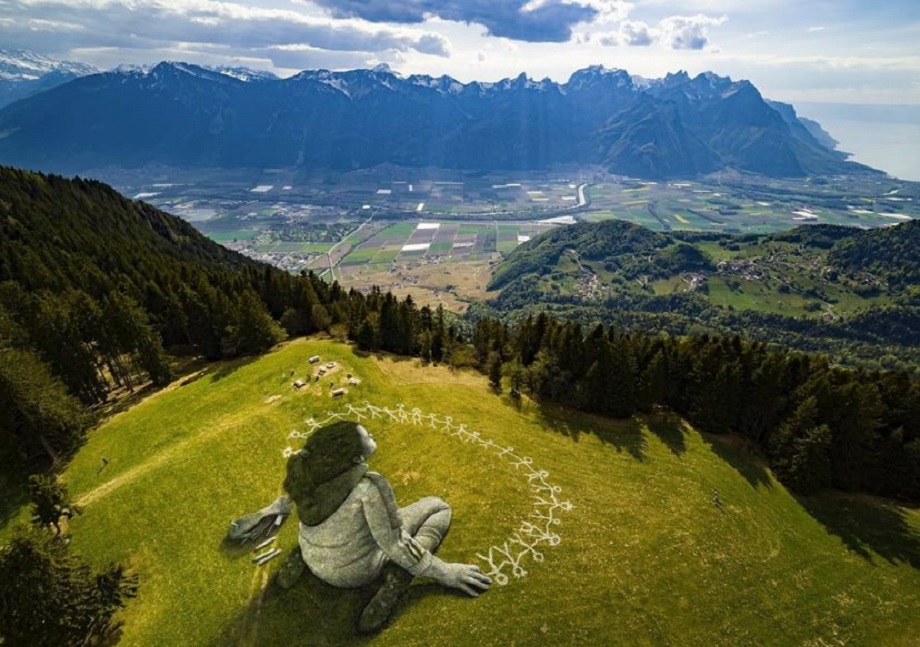 Umelec nakreslil obrie dievčatko v tráve