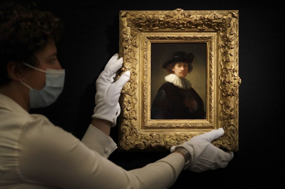 Na archívnej snímke z 23. júla 2020 zamestnankyňa aukčného domu Sotheby's drží autoportrét holandského maliara Rembrandta van Rijna