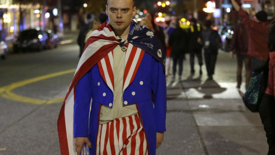 Muž oblečený vo farbách americkej vlajky počas protestu proti novozvolenému prezidentovi Donaldovi Trumpovi, 9. novembra 2016.